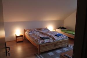 two beds in a room with two lamps on them at Ubytovanie Eva in Oščadnica +44 photos