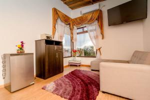 a living room with a couch and a window at Encanto Hotel Boutique in Santa Marta
