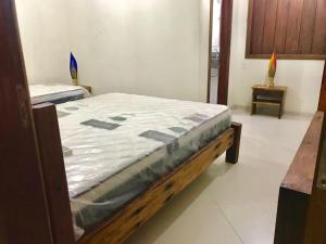 a bed sitting in a room with a mattress at Casa Barra Grande in Barra Grande