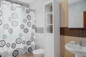 a bathroom with a shower curtain and a sink at Suncity Flat Gigantes in Málaga