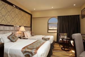 a hotel room with two beds and a window at Al Muhaidb Residence Al Ahsa in Al Ahsa +46 photos