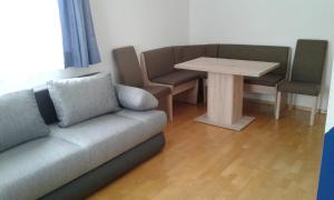 a living room with a couch and a table at Ferienwohnung Susanne in Ulrichsberg