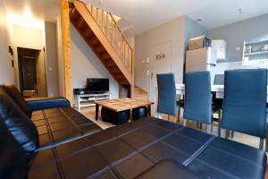 a living room with a couch and a table with chairs at Appart'Hôtel de la Tour in Troyes