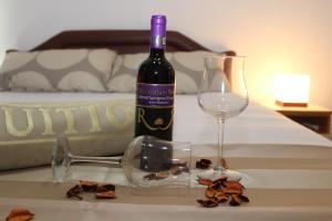a bottle of wine and glasses on a table at Apartments Perezaj II in Ulcinj