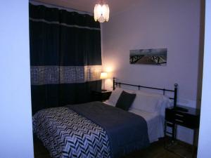 a bedroom with a bed with a black and white blanket at Hostal Don Pepe in Figueres