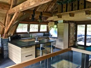 a kitchen with a large island in a wooden house at Gîte Bodenmatt in Muhlbach-sur-Munster