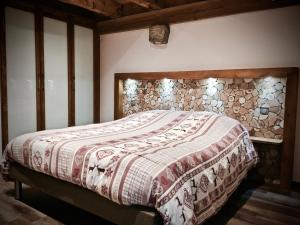 a bedroom with a bed with a blanket on it at Gîte Bodenmatt in Muhlbach-sur-Munster