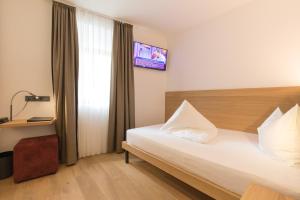 Voodi või voodid majutusasutuse Belvenu Boutique Hotel toas
