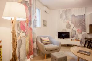a living room with a chair and a lamp at Acropolis Quiet Apartment in Athens