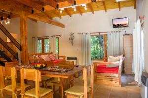 a living room with a wooden table and a couch at Arcangeles in San Carlos de Bariloche