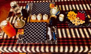 a picnic blanket with food and utensils on it at La Residencia B&B in Boca Chica