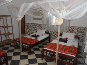 Postel nebo postele na pokoji v ubytování Kimte Beach Lodge