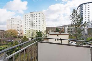 a balcony in a city with tall buildings at Bianco Apartament in Gdynia