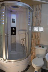 a bathroom with a shower with a toilet and a sink at NUESTRA CASA - OUR HOME Cuenca by A2CC in Ricaurte