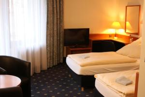 Un pat sau paturi într-o cameră la Karaman Group Hotel