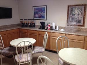 a kitchen with two tables and chairs and a counter at Budget Inn Express Bristol in Bristol