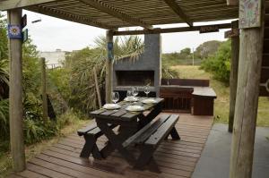 a wooden deck with a table with wine glasses at Maravillosa in La Pedrera