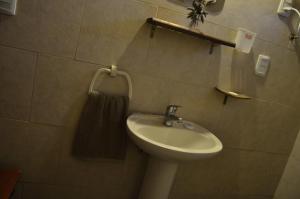 a bathroom with a sink and a towel rack at Maravillosa in La Pedrera