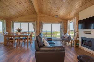 a living room with a couch and a table at The Chalet, Holidays for All in Dunbar