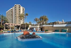 a large swimming pool with a large swimming pool behind it at Sol Tenerife in Playa de las Americas