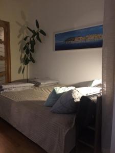 a bedroom with two beds and a plant on the wall at Apartment Boris in Niš