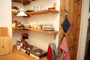 a small kitchen with a stove and some plates at Willes B&B in Copenhagen