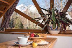a table with a plate of food and a cup of coffee at Penzion Slnecny Dom in Tatranská Lomnica +31 photos
