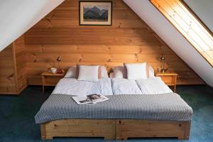 a bedroom with two beds in a attic at Penzion Slnecny Dom in Tatranská Lomnica