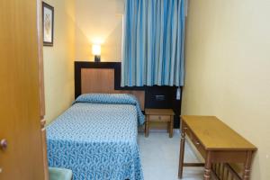 Posteľ alebo postele v izbe v ubytovaní Hostal La Palmera