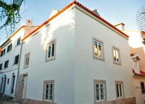 a white house with a red roof at Apartments Uppe Villa in Lisbon