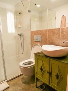 a bathroom with a sink and a toilet and a shower at Apartments Uppe Villa in Lisbon