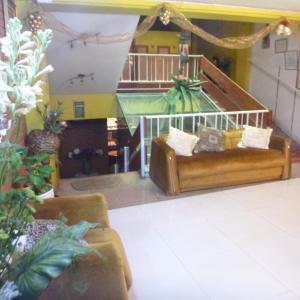 a living room with a couch and some plants at Hostal Retama Inn in Huancayo