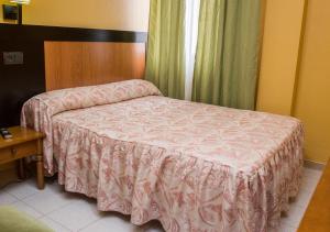 Posteľ alebo postele v izbe v ubytovaní Hostal La Palmera