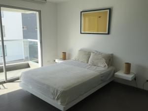 Tempat tidur dalam kamar di Paracas Apartment