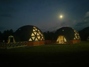 a couple of domes with the moon in the background at Domos Elohim in Pucón