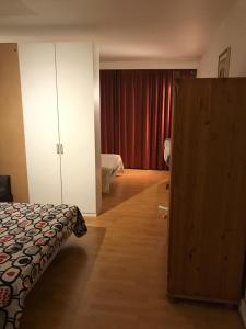 
a bedroom with a bed and a dresser at Apartment Zaventem Brussels Airport C in Zaventem
