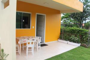 a patio with a table and chairs outside of a house at Refúgio do Bosque in Penha
