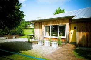 a wooden cabin with a picnic table and a bench at Jugendherberge Ottobeuren - membership required in Ottobeuren