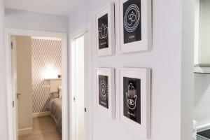 a room with three framed pictures on the wall at Apartamento Garval Valladolid in Valladolid