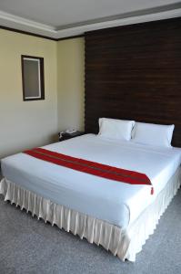 
A bed or beds in a room at Karon Bay Inn
