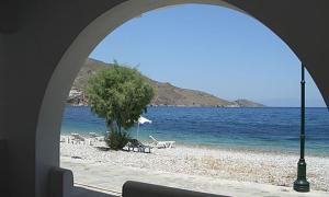 a view of a beach from an archway at Kleopatra's Rooms in Livadia