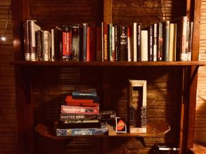 a book shelf filled with lots of books at Casa Kresala, Surf House in Zorritos