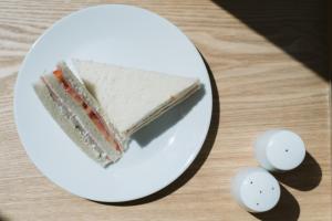 a piece of cake on a white plate on a table at Thomson Residence Hotel in Bangkok