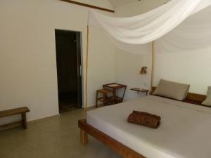 a bedroom with a bed and a dresser at Om Home in Sihanoukville
