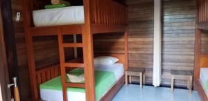 a bunk bed room with two bunk beds in it at Surya Home Stay in Nusa Lembongan