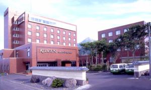 a building with a sign on the side of a street at Kitaguni Grand Hotel in Rishirifuji