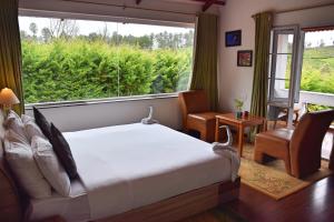 Postel nebo postele na pokoji v ubytování Green Nest Resort Ooty