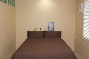 a bed in a bedroom with a brown bedspread at Laguna Bel-Air Home in Sta Rosa #15 by Red Door House Rental in Santa Rosa