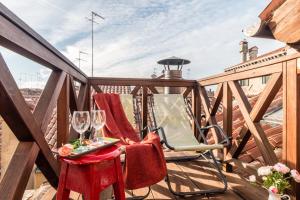 balkon z 2 krzesłami i stołem z kieliszkami do wina w obiekcie Rialto Mini w Wenecji