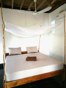 a bed that has a canopy over it at Om Home in Sihanoukville